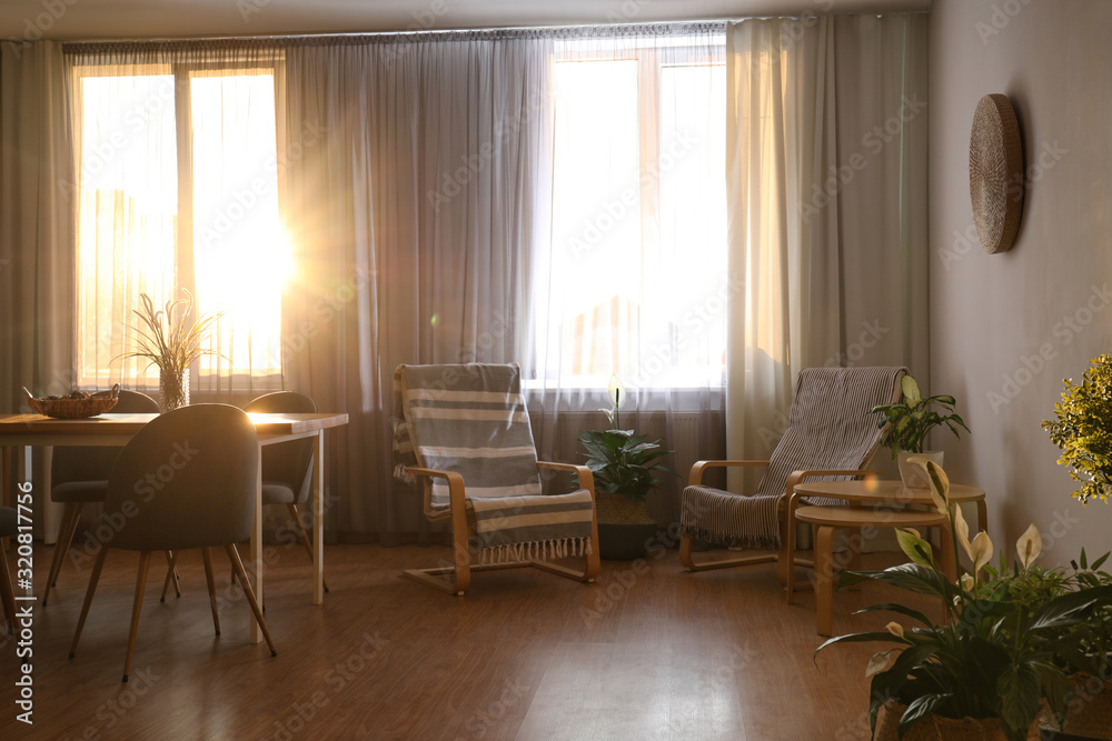 Windows with stylish curtains in living room interior Windows with stylish curtains in living room interior
