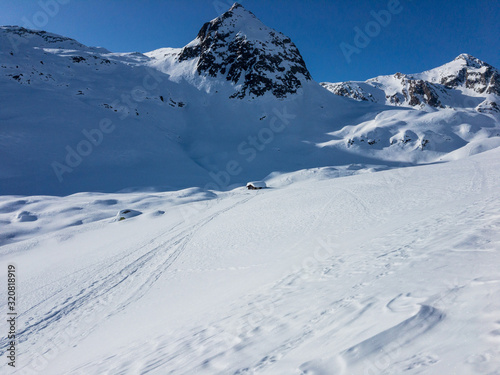 Panoramic winter view of the snowy valley at the Lucomanio pass in Switzerland. © serghi8