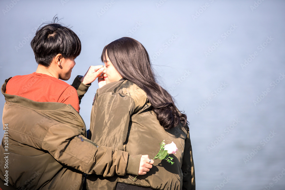 LGBT Asian teenage couples visit the seaside on a clear day and happily show their love for one another.