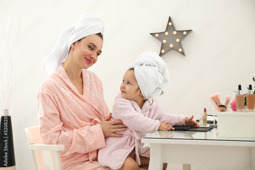 Young mother and little daughter at dressing table Young mother and little daughter at dressing table