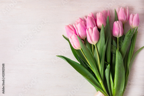 Fototapeta Naklejka Na Ścianę i Meble -  Beautiful pink spring tulips on white wooden background, top view. Space for text