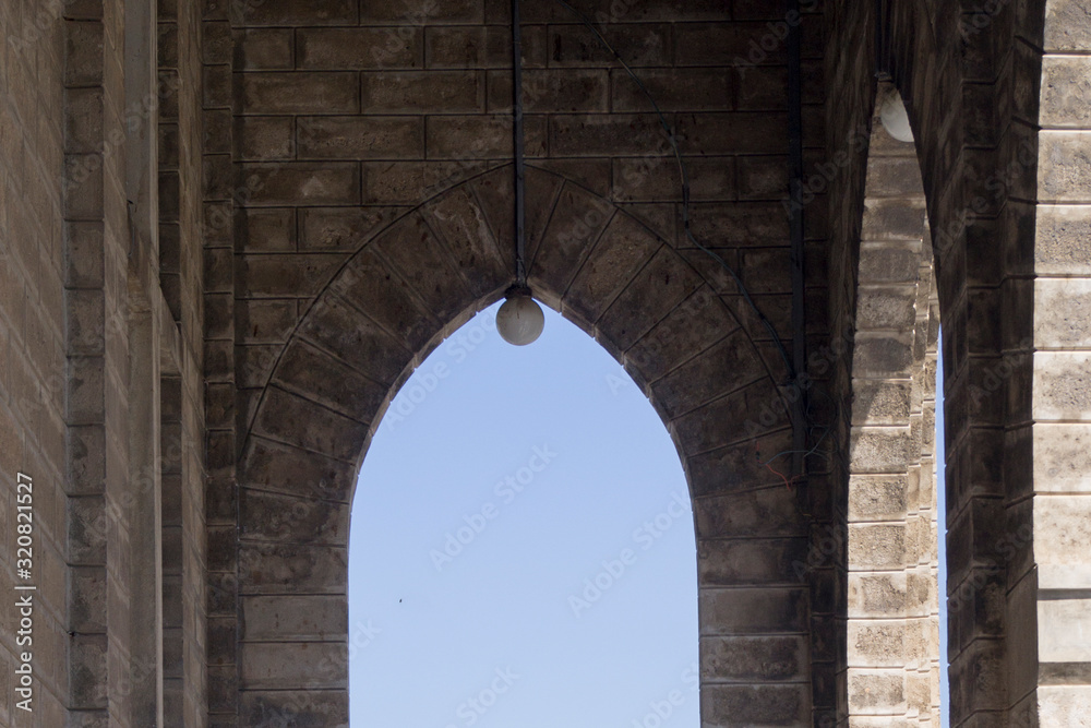 arch in a catholic temple against the sky
