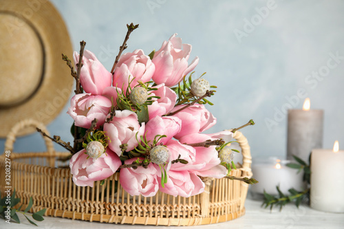 Beautiful bouquet with spring pink tulips on table