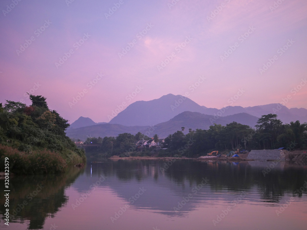River curve with a mountain view in the evening time, a shore is under construction