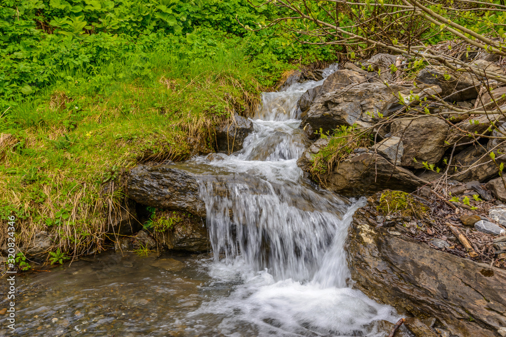Fototapeta premium Mountain waterfall near Murren, Switzerland