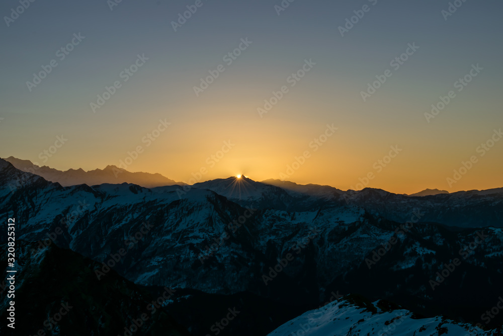 Fototapeta premium Sequences of Sunrise Kedarkantha peak in Uttarakhand Himalayas. Beautiful shots taken from sunrise time lapse during winter trek to Kedarkantha, Uttarkashi (Uttarakhand, India) on New year