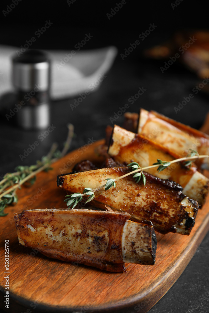 Delicious roasted ribs served on wooden board
