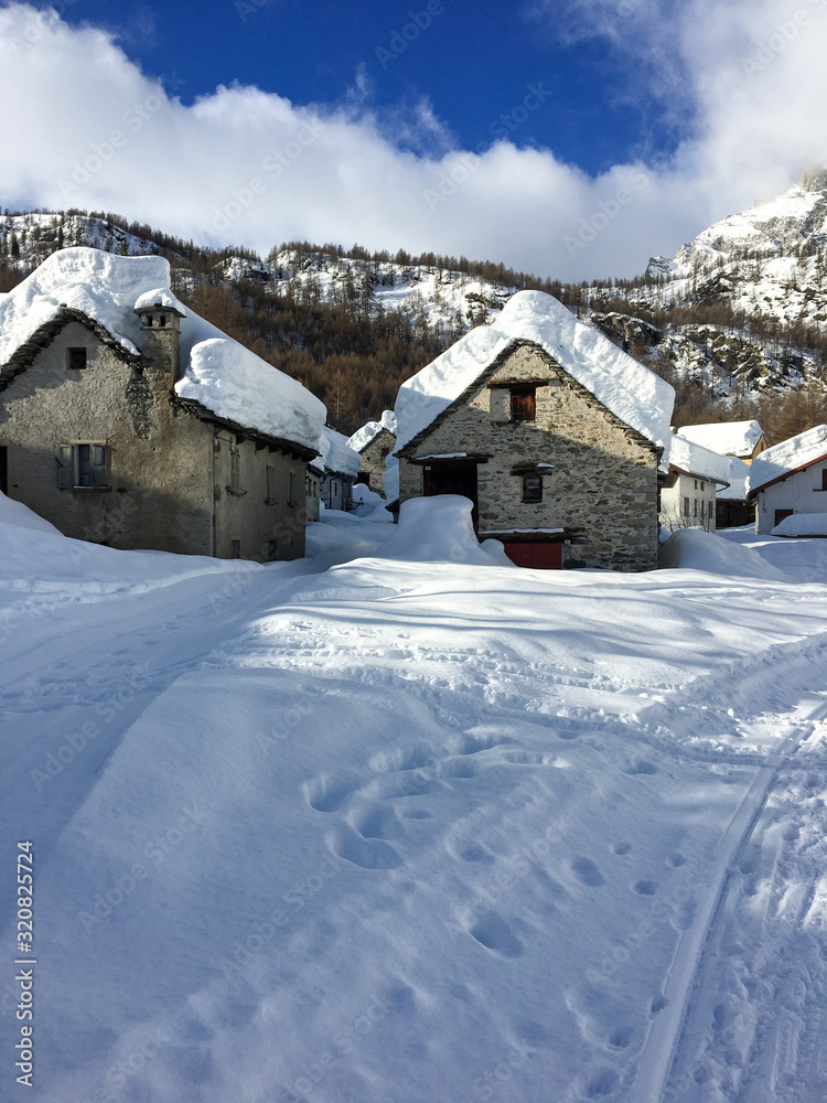 Panoramic view after a heavy snowfall, of the huts of the Alpe Devero village in Piedmont Italy