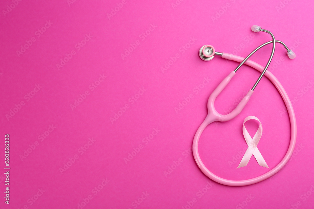 Pink ribbon as breast cancer awareness symbol and stethoscope on color background, flat lay. Space for text Pink ribbon as breast cancer awareness symbol and stethoscope on color background, flat lay. Space for text
