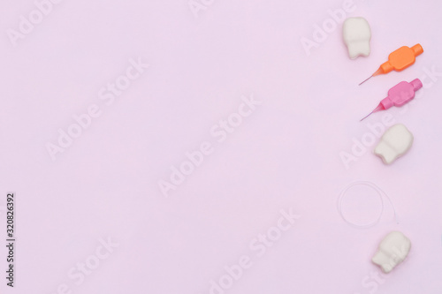 Flat lay composition with oral care products on pink background. Dental care and healthy teeth concept. Copy space.