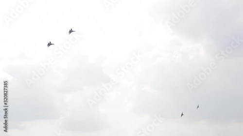 Four fighter jets in the blue sky. A general plan. Aerobatic figures. Airshow. 11 seconds