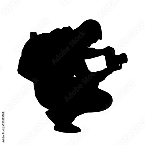 Silhouette of a male photographer, he photographs in a squat pose. Vector.