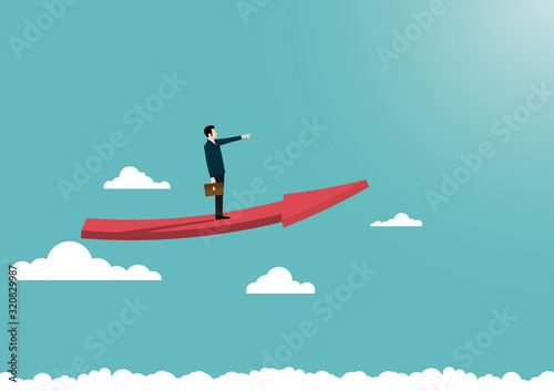 Businessman stand on arrow flying over the clouds