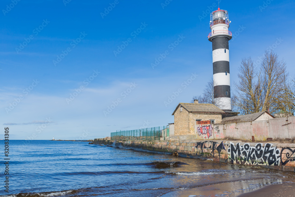 City, Riga, Latvia. Baltic Sea with waves and lighthouse. Travel photo.