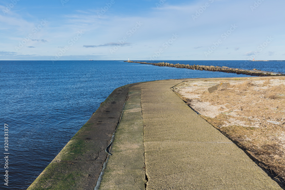 City, Riga, Latvia. Baltic Sea with waves and mole. Travel photo.