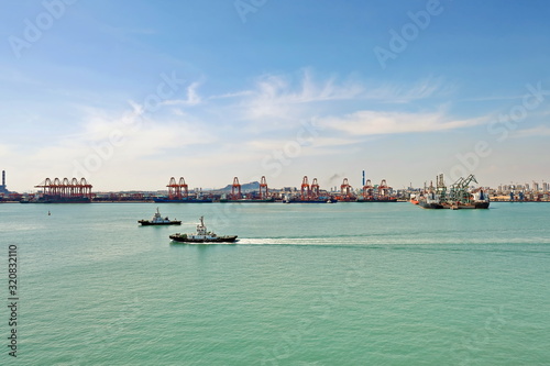 Panoramic views of piers, sea vessels, tugboats and the city of Rizhao, China. photo