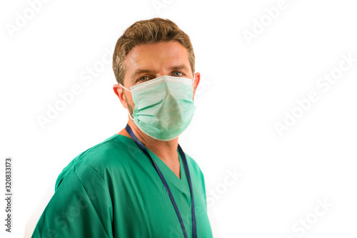 attractive and successful medicine doctor or nurse man posing confident for hospital staff corporate portrait in green medical uniform and face mask isolated on white