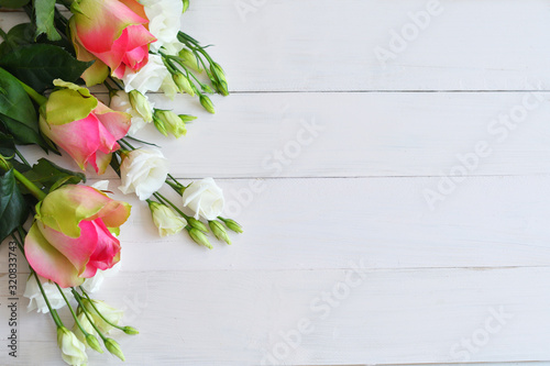 Valentines Day romantic background with flowers. Valentine Card with copy space. Flowers eustomas and roses on pink background. Valentine s day greeting card template February 14.