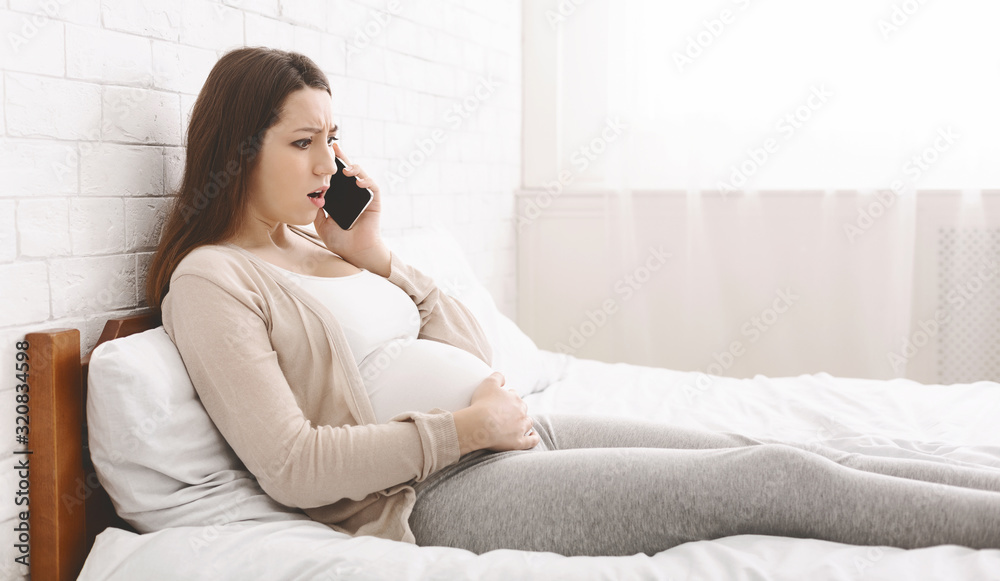 Young pregnant woman feeling some pain and discomfort Young pregnant woman feeling some pain and discomfort