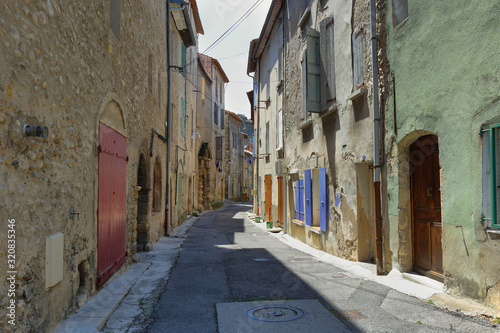 Fototapeta Naklejka Na Ścianę i Meble -  Deserted colorful medieval street in Les Mees village, Provence, France