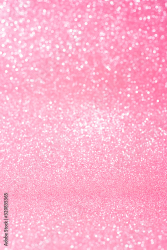 Vertical pink glitter background with blur and bokeh