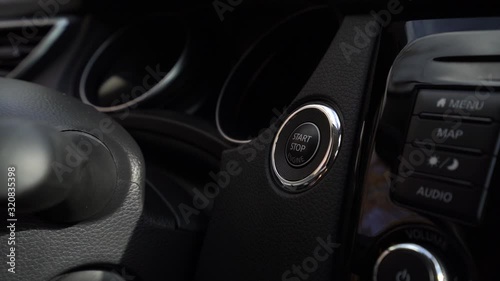  Men hand pushing on the start button of a suv car