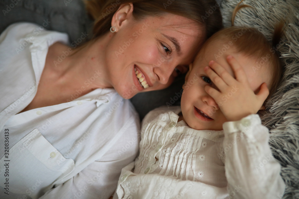 Mother and daughter lie on the bed and have a fun. Mother and daughter lie on the bed and have a fun.