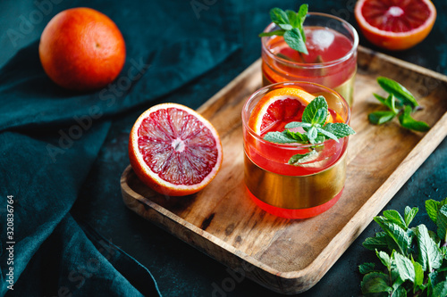 Refreshing cold summer cocktail with blood orange and mint.