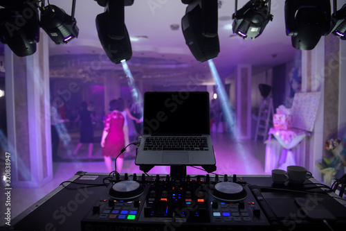 close up photo of a mixing desk in the dark at a wedding