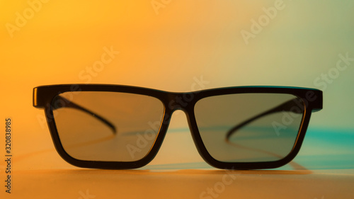 3D cinema glasses close-up on a colored background