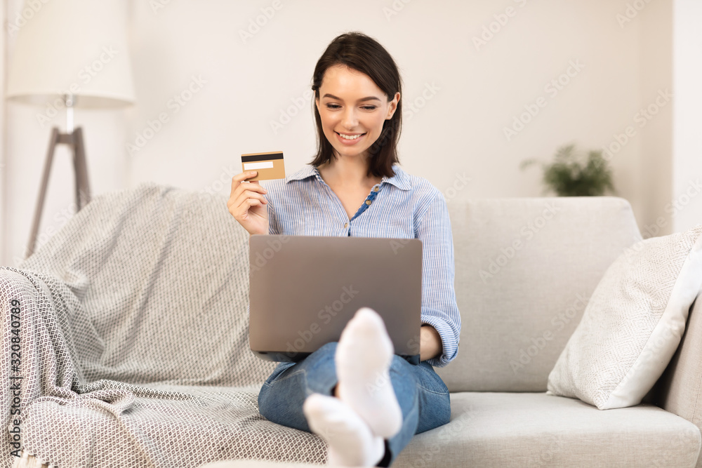 Young woman making purchases sitting on the couch Young woman making purchases sitting on the couch