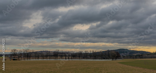 Field and hills near Hreben pond village in cloudy day in south Bohemia photo