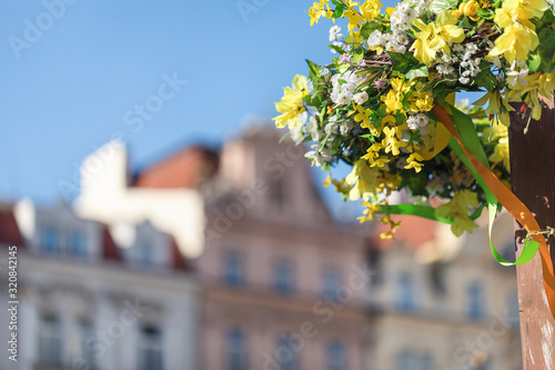 Photography Easter outdoor flower decorations on the streets of Prague, blurred historical b