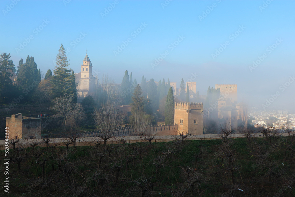 panoramic view of the Alhambra in the winter morning haze panoramic view of the Alhambra in the winter morning haze