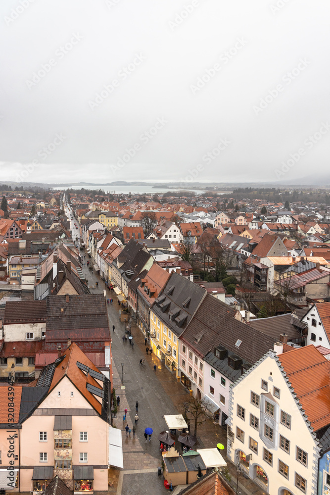 Aerial view of the old town of Fussen on a cloudy winter day from the Hohes Schloss castle, with the Forggensee lake in background, Allgaeu, Bavaria, Germany