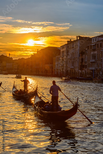 Grand Canal with gondolas in Venice, Italy. Sunset view of Venice Grand Canal. Architecture and landmarks of Venice. Venice postcard