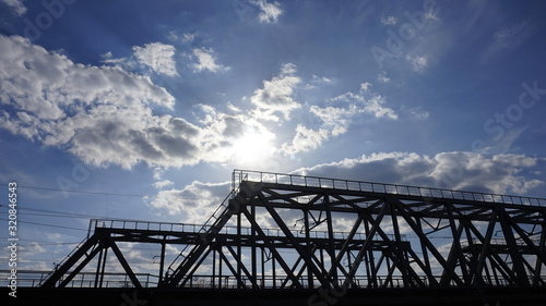 metal construction of a railway bridge against a blue sky © St
