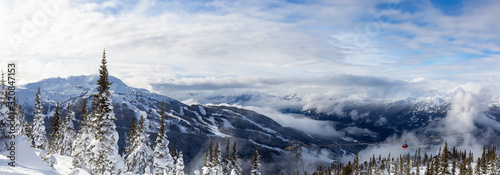 Whistler, British Columbia, Canada. Beautiful Panoramic View of the Canadian Snow Covered Mountain Landscape during a cloudy and vibrant winter day.