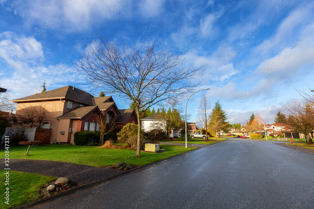 Residential Suburban Neighborhood in the City during a vibrant winter sunrise. Taken in Fraser Heights, Surrey, Vancouver, BC, Canada. Wide Angle Residential Suburban Neighborhood in the City during a vibrant winter sunrise. Taken in Fraser Heights, Surrey, Vancouver, BC, Canada. Wide Angle