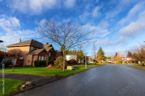 Residential Suburban Neighborhood in the City during a vibrant winter sunrise. Taken in Fraser Heights, Surrey, Vancouver, BC, Canada. Wide Angle