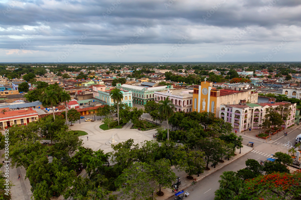 Ciego de Avila, Cuba - June 14, 2019: Aerial Panoramic view of a small Cuban Town during a cloudy and colorful sunset.