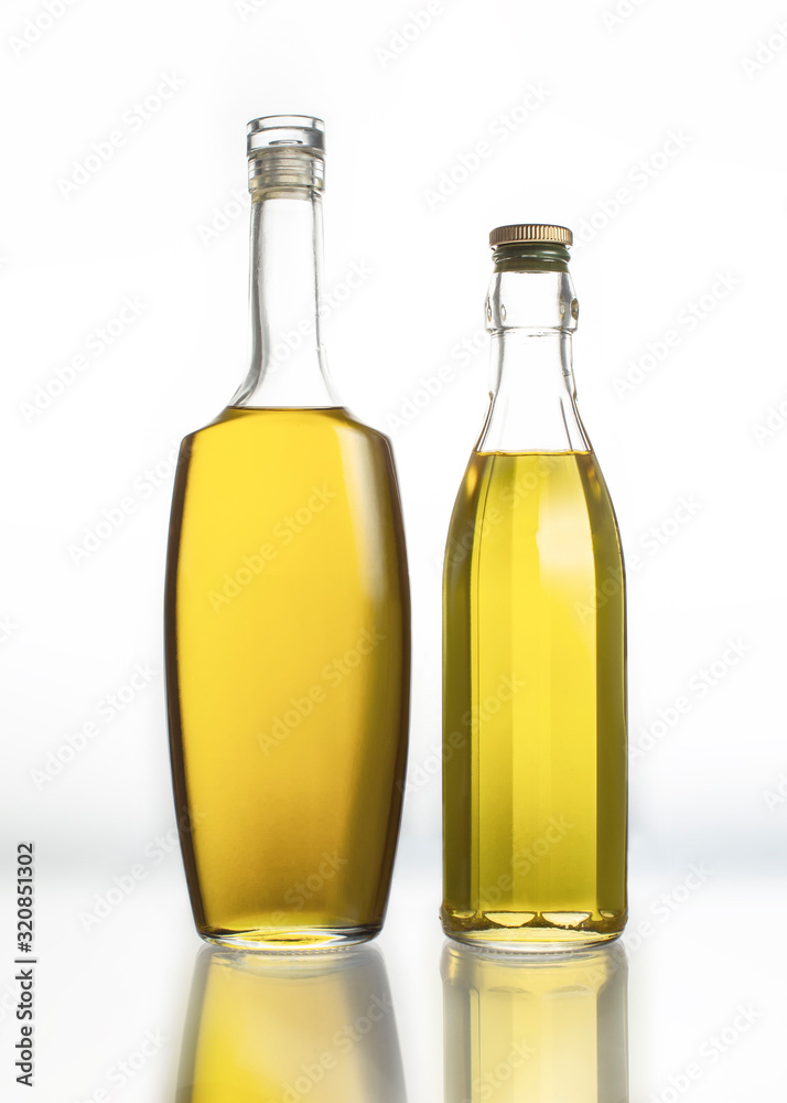 Two bottles with olive oil isolated on a white background Two bottles with olive oil isolated on a white background