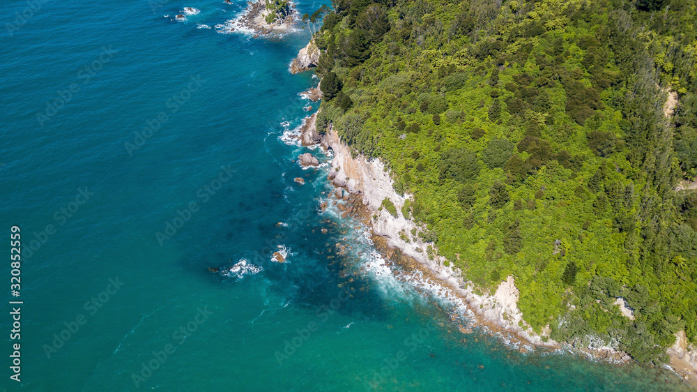 Above steep cliffs with green trees and blue ocean