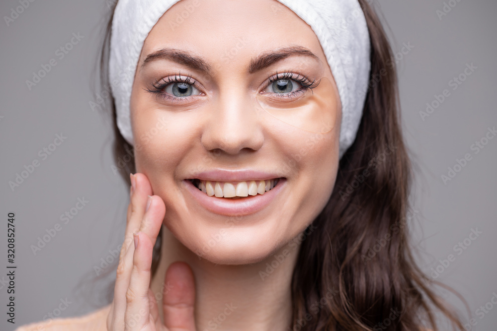 Patch Under Eye. Beautiful Happy Smiling Woman With Moisturizing eye patches, Face. Skin Care Product On White Background. Сare of skin Patch Under Eye. Beautiful Happy Smiling Woman With Moisturizing eye patches, Face. Skin Care Product On White Background. Сare of skin