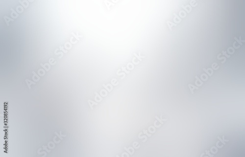 Shiny silver plain background. Smooth metallic light blur texture. Flare and shades abstract illustration. photo