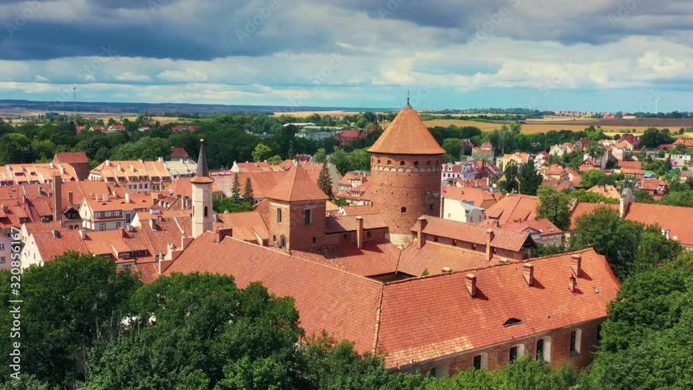 View from the drone perspective on medieval castle and church. View from the drone perspective on medieval castle and church.