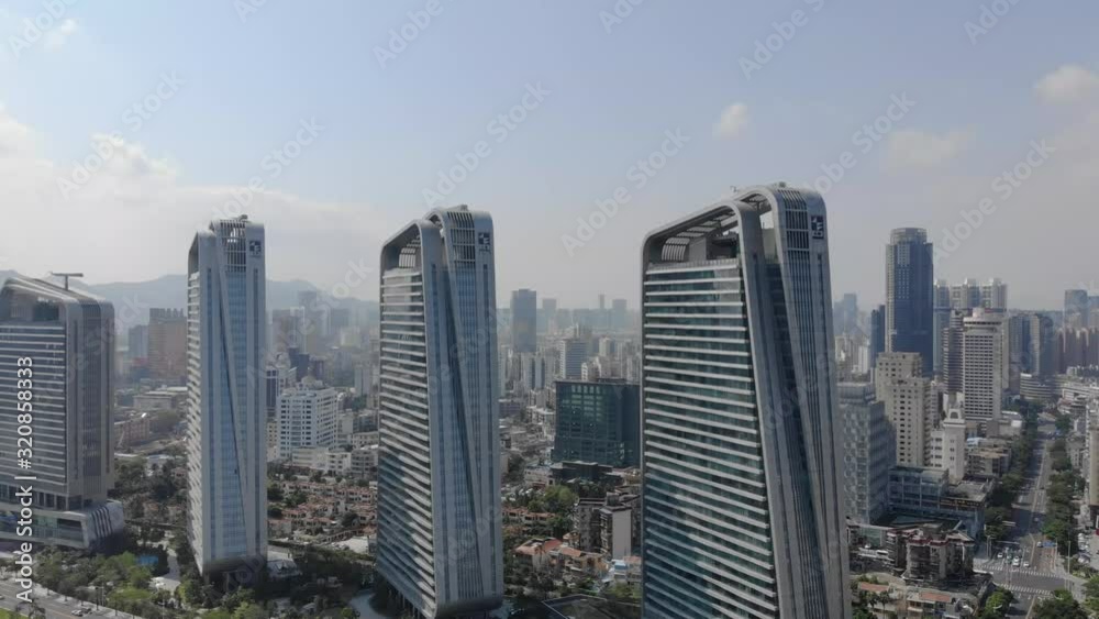 Rising sideways aerial shot of Zhuhai cityscape and skyscrapers on clear sunny day Rising sideways aerial shot of Zhuhai cityscape and skyscrapers on clear sunny day