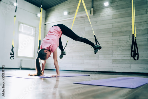 Female athlete doing handstand while stretching