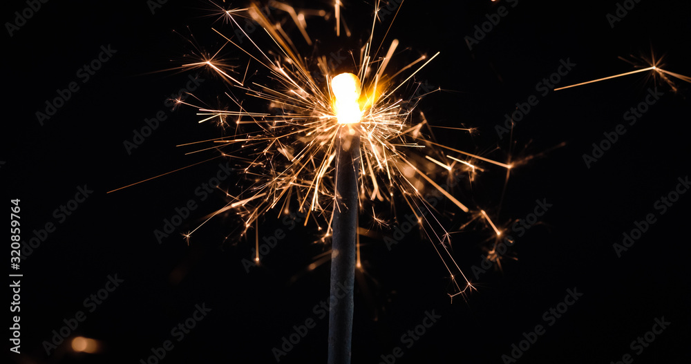 Obraz premium Firework festive sparkler burning on black background