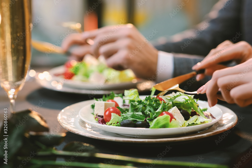 Closeup Of Unrecognizable Couple Eating Greek Salad At Dinner In Restaurant